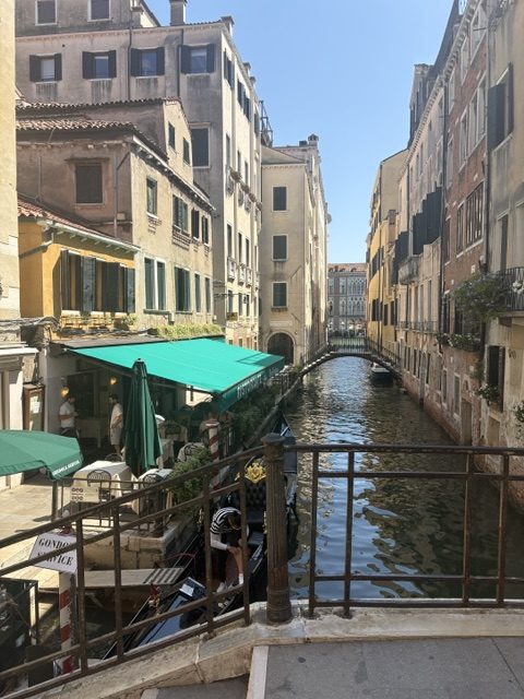 Narrow canal with restaurant awnings